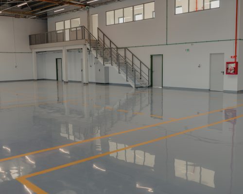 Epoxy and waxed flooring with colorful signage in car service