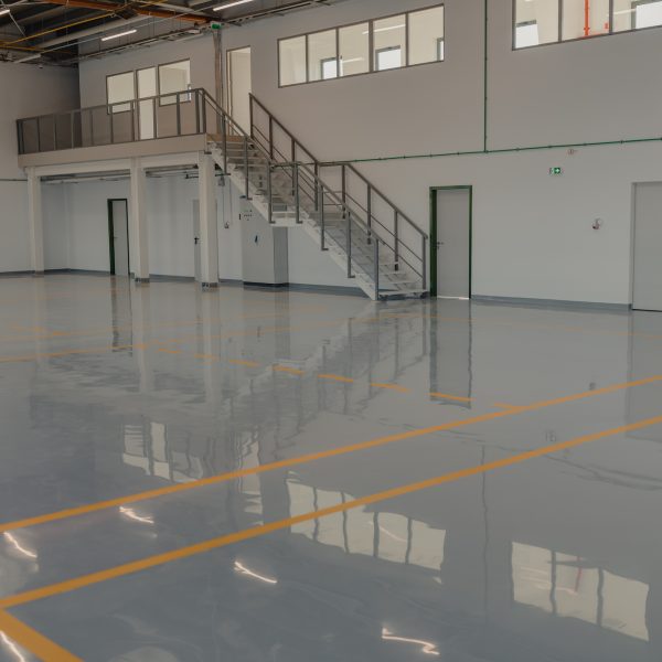 Epoxy and waxed flooring with colorful signage in car service